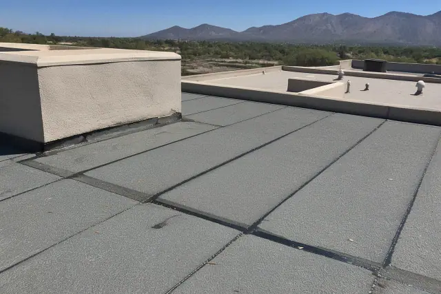 Modified bitumen roof repair with heat-welded seams on a commercial building rooftop in Tucson, AZ.