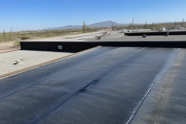 Heat-welded modified bitumen roofing seams on a commercial building rooftop in Tucson, AZ.