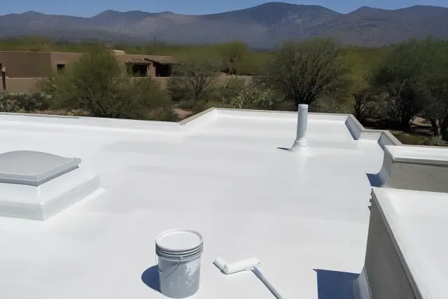 Pressure washer cleaning weathered roof shingles in the bright desert sunlight of Vail, AZ.