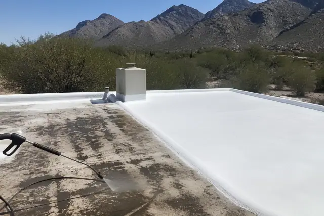 Reflective white roof coating being applied to a weathered residential roof in Tanque Verde, AZ.