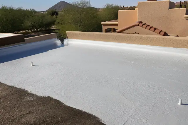 Fresh white roof coating being applied to a flat residential roof in Sahuarita, AZ.