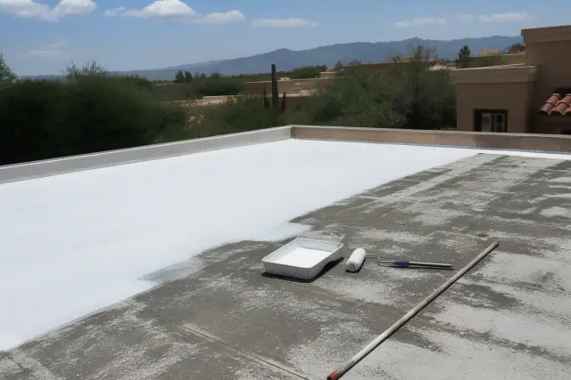 White reflective roof coating being applied to a flat residential roof in Green Valley, AZ.