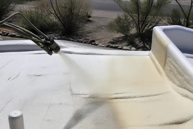 Polyurethane foam being sprayed onto a residential roof in Tucson, AZ.