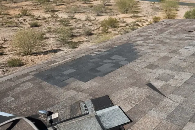 Fresh shingles being patched into an older roof during a repair project in Vail, AZ.