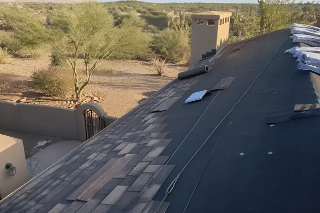 Contractor installing shingles on a steep-sloped roof at a home in Green Valley, AZ.