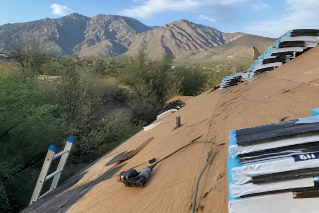 Shingle bundles secured to a steep-sloped roof during a construction project in Oro Valley, AZ.