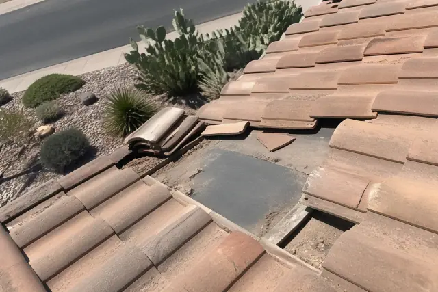 Clay roof tiles being repaired at a residential home with desert landscaping in Tucson, AZ.