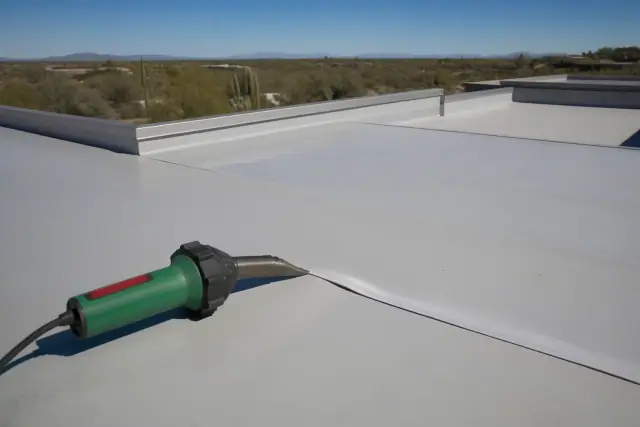 Heat-welded TPO roof membrane seam repair on a commercial building rooftop in Tucson, AZ.