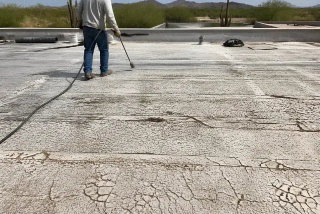 Professional applying heat-welded seams to a commercial roof with alligatoring and leaks in Tucson, AZ.