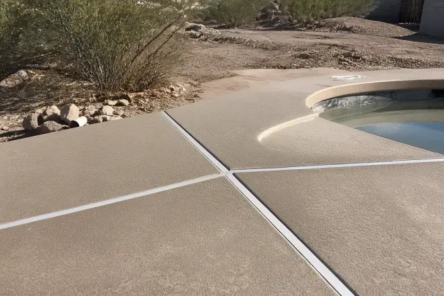 Flexible sealant installed in concrete pool deck expansion joints at a residential job site in Marana, AZ.