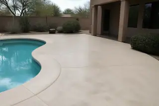 Newly finished textured concrete pool deck with stucco home architecture and desert landscaping in Tucson, AZ.