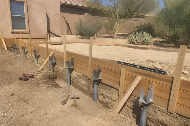 Helical piers installed next to wooden foundation forms at a residential jobsite in Tucson, AZ.