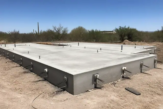 Post-tension concrete foundation with anchored steel cable ends at a construction site in Tucson, AZ.