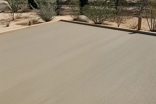 Standard broom finish on a fresh concrete patio with Sonoran desert landscaping in Tucson, AZ.