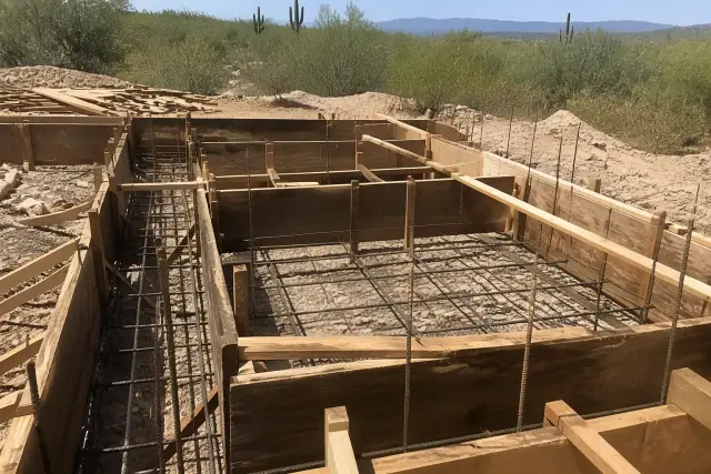 Wooden foundation formwork with structural rebar at a construction site in Tucson, AZ.